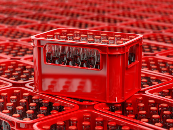 A large group of plastic crates filled with glass bottles, both the crates and the bottles are examples of returnable assets that can be tracked with RFID technology.